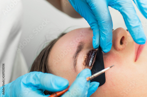 Eyelash lamination procedure. Staining, curling, laminating, lash lift. Eyelash Extension. Lengthening lashes for girl in beauty salon. Beauty Concept.