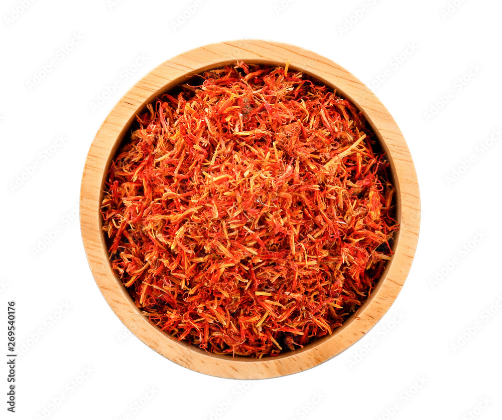 Safflower dried in wood bowl on white background Safflower dried in wood bowl on white background