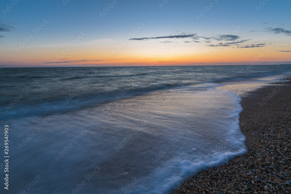 photo on long exposure, waves at sea at sunset