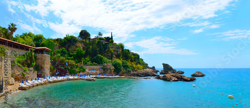 Fototapeta Naklejka Na Ścianę i Meble -  Mermerli Plaji or Mermerli beach with clear azure water in old town Kaleici district city Antalya