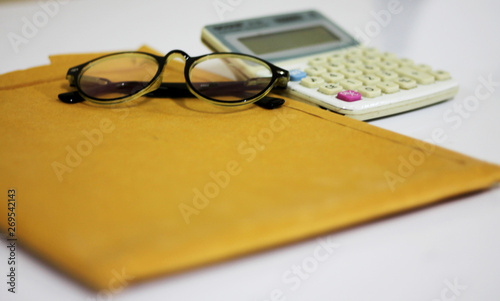 glasses and calcul. . ator on paper