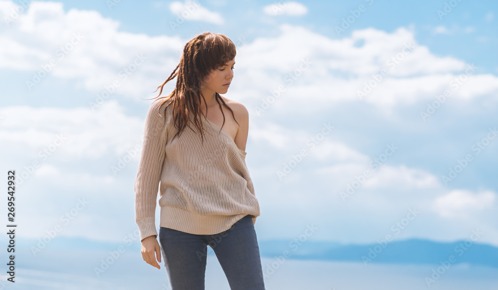 Young asian woman dancing over blue sky background. Young asian woman dancing over blue sky background.