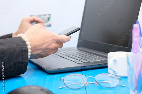 Businessman and woman working a smartphone and laptop 