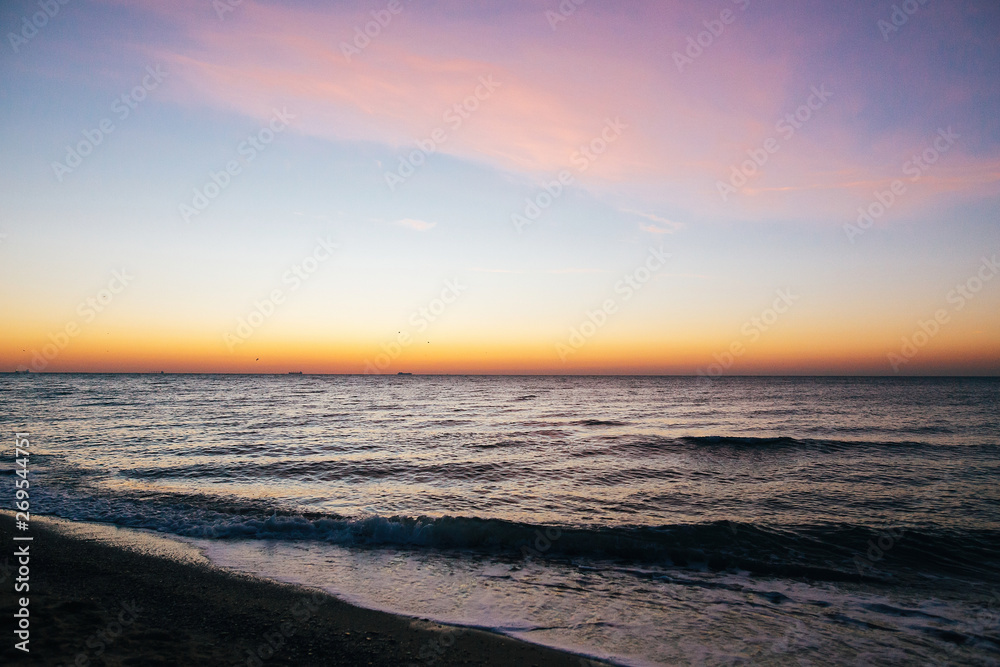 Beautiful sea waves foam closeup and pink sky in sunrise light on tropical island. Waves in ocean at sunset. Tranquil calm moment. Summer vacation. Copy space Beautiful sea waves foam closeup and pink sky in sunrise light on tropical island. Waves in ocean at sunset. Tranquil calm moment. Summer vacation. Copy space