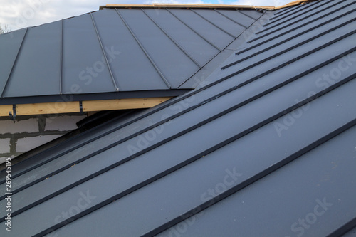 close up view of  house under construction with grey folding roof on waterproofing layer