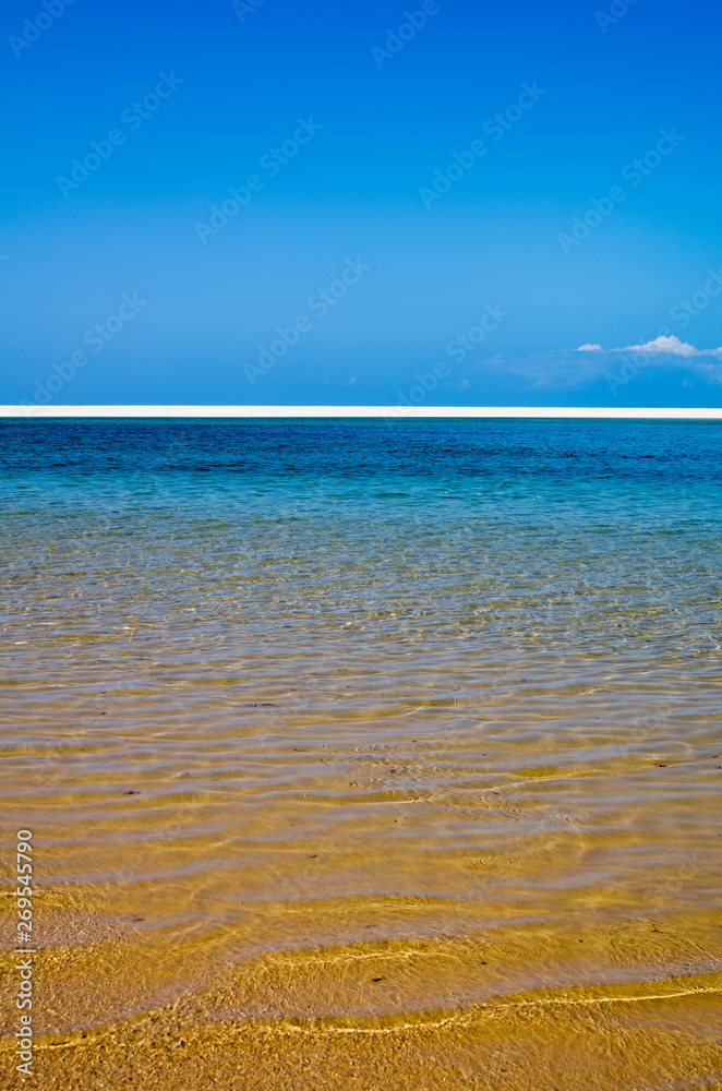 White beach with tropical sand and coral and blue sea background. Mozambique. Vilankulos