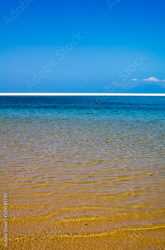 White beach with tropical sand and coral and blue sea background. Mozambique. Vilankulos