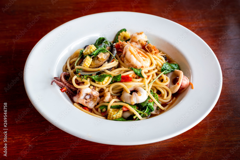 seafood - stir fried spaghetti with seafood in hot and spicy thai style seafood - stir fried spaghetti with seafood in hot and spicy thai style