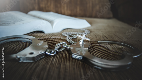 christian cross with handcuffs, concept of Jesus christ the savior liberate people from sin.