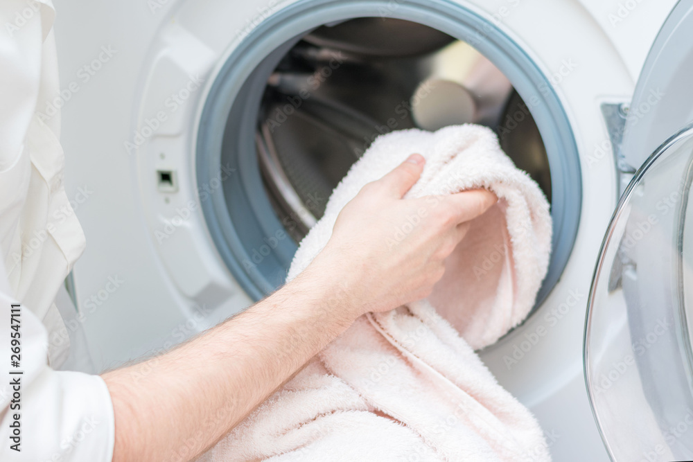 Man with washing machine, washing clothes, closeup Man with washing machine, washing clothes, closeup