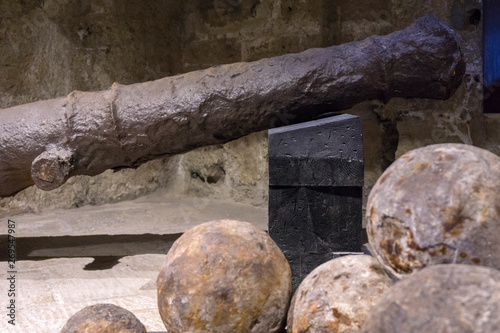 Heraklion, Crete Island/ Greece. Fortress Koules (Castello a Mare). Old rusty Venetian cannon, cannon balls inside the fortress Koules. Intentional focus on the cannon