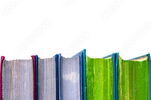 Old books standing in a row on white background