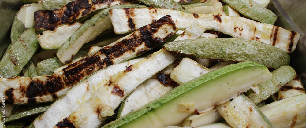 Roasted zucchini. Delicious drilled green zucchini with garlic and herbs. Vegetables on a barbecue. Grill and summer concept. Healthy eating. Detox. Roasted zucchini. Delicious drilled green zucchini with garlic and herbs. Vegetables on a barbecue. Grill and summer concept. Healthy eating. Detox.