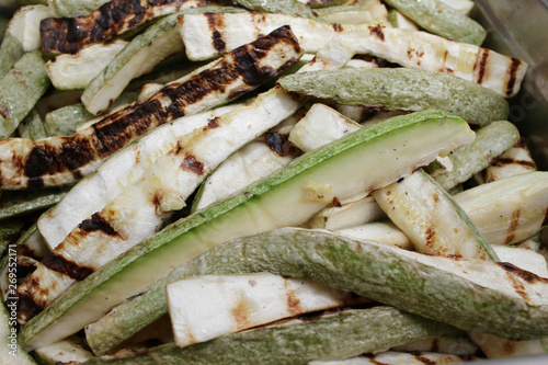 Roasted zucchini. Delicious drilled green zucchini with garlic and herbs. Vegetables on a barbecue. Grill and summer concept. Healthy eating. Detox.