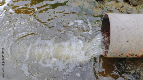 Water gushing from the sewer, river pollution