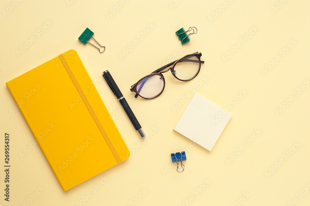 Empty notebook and office stationery yellow background. Empty notebook and office stationery yellow background.