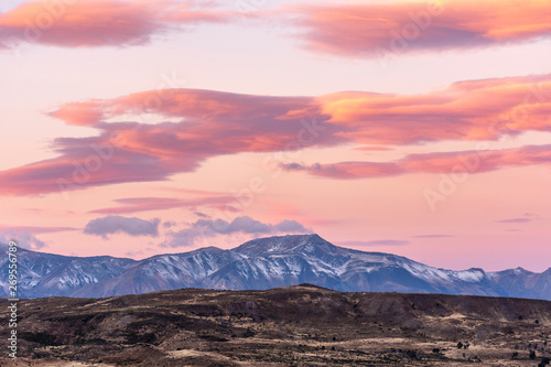 Colorful and vibrant sunset against snowcapped mountains