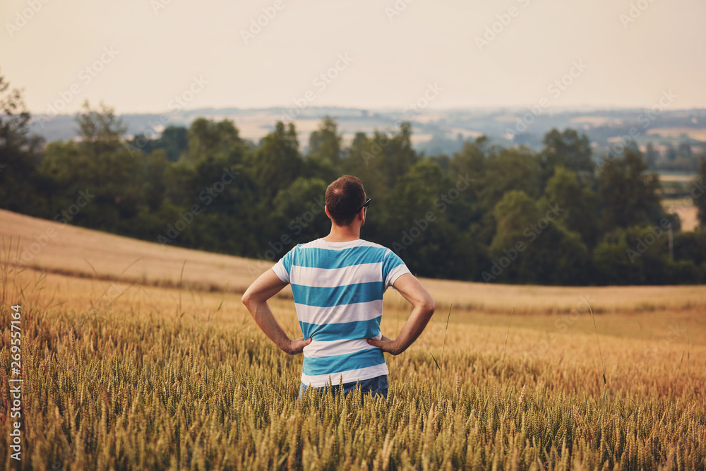 Man enjoying and relaxing in wheat field. Nature concept. Man enjoying and relaxing in wheat field. Nature concept.
