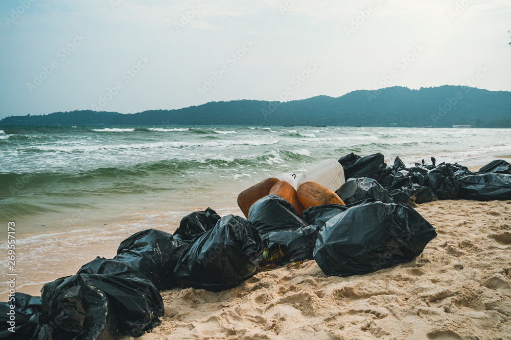 Garbage bags. Blue plastic garbage bags full of trash on the beach