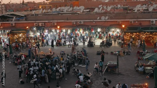 MARRAKECH, MOROCCO - MAY 15 2019: Djemaa El-fna at Marrakech, Morocco. Top view of the UNESCO square on ramadan kareem on sunset photo