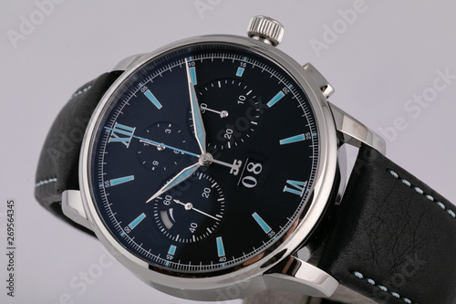 Mens silver watch with a black dial, blue clockwise, chronograph, stopwatch, with a black leather strap with blue line.