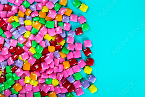 different color chewing gum on blue background