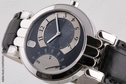 Female silver watch with a black dial, silver clockwise, stopwatch with a black leather strap. 