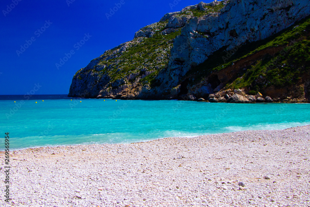Fototapeta premium tropical beach in Spain one beach with stones with turquoise water