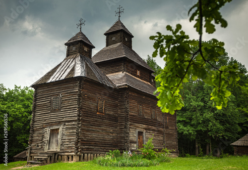 Orthodox wooden church in the Ukrainian village under dramatic skies