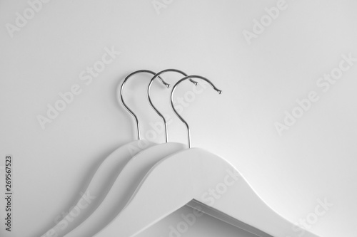 Empty clothes hangers on white background, top view