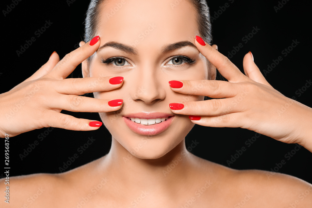 Beautiful young woman with bright manicure on black background, closeup. Nail polish trends Beautiful young woman with bright manicure on black background, closeup. Nail polish trends