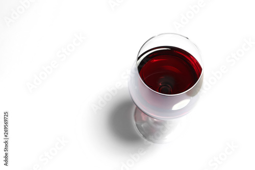 Glass of red wine on white background, above view. Space for text