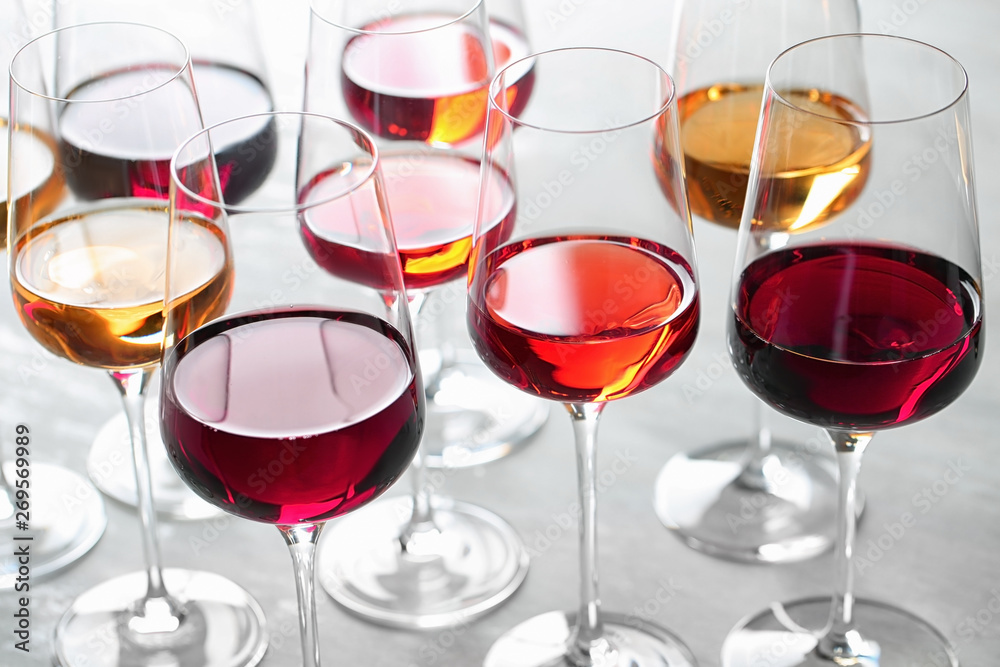 Group of glasses with different wines on light table Group of glasses with different wines on light table