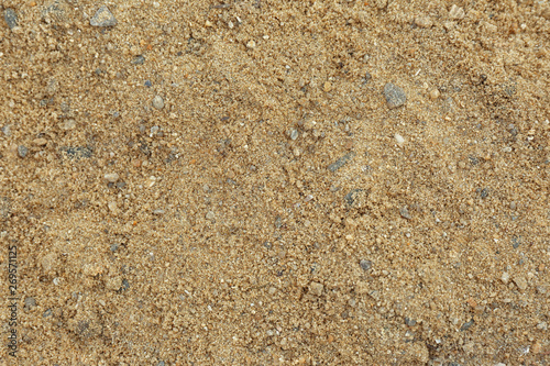 Textured sandy soil surface as background, top view