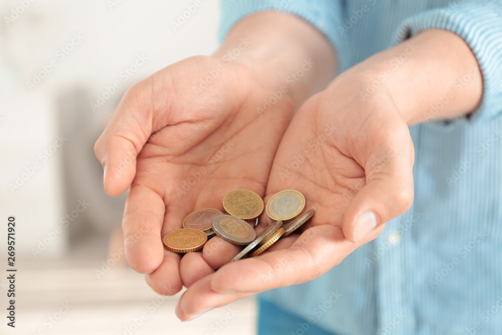Man holding coins in hands indoors, closeup Man holding coins in hands indoors, closeup
