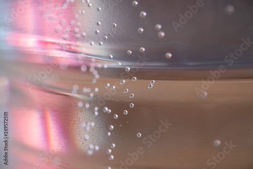 Many small air bubbles floating over a pink background. Abstract colorful Background