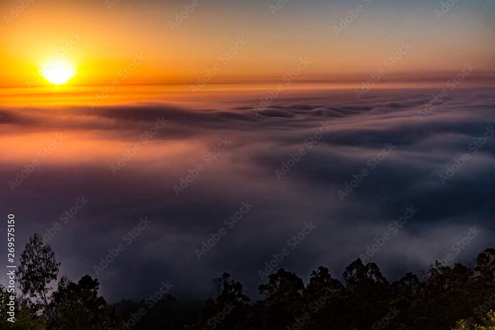 sunset in mountains with fog