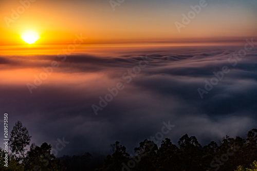 sunset in mountains with fog