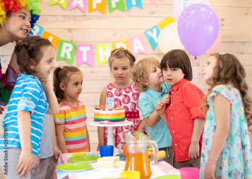 Group of children at birthday party. Cute little kid congratulating friend birthday boy