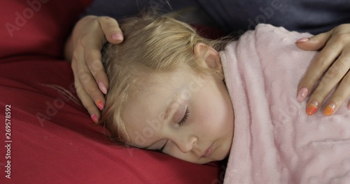 Cute baby sleeping on the bed at home. Little girl sleeping in morning light