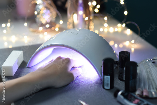 Obraz na płótnie Making a manicure, hybrid polish, uv lamp, beautician work