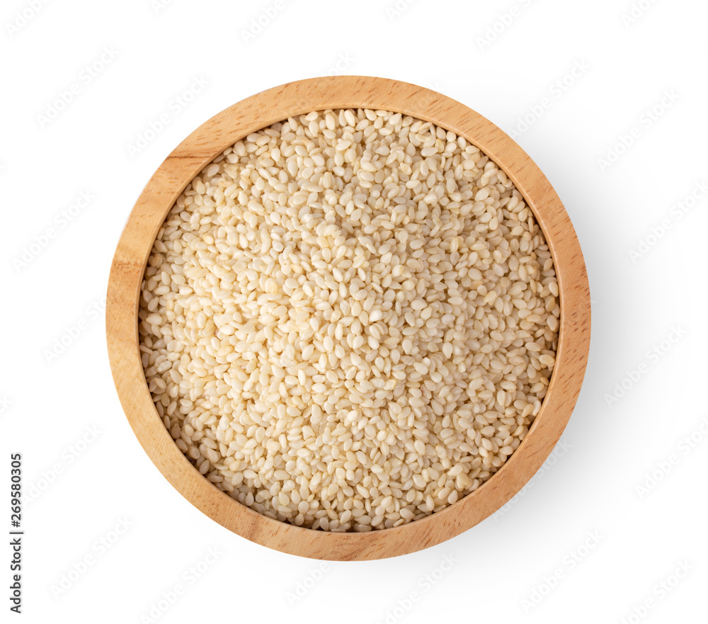 Sesame seeds in a woodenbowl isolated on white background Sesame seeds in a woodenbowl isolated on white background