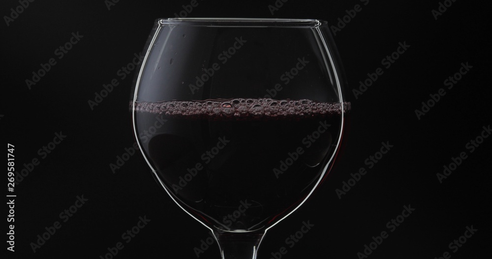 Rose wine. Red wine in wine glass over black background. Silhouette Rose wine. Red wine in wine glass over black background. Silhouette