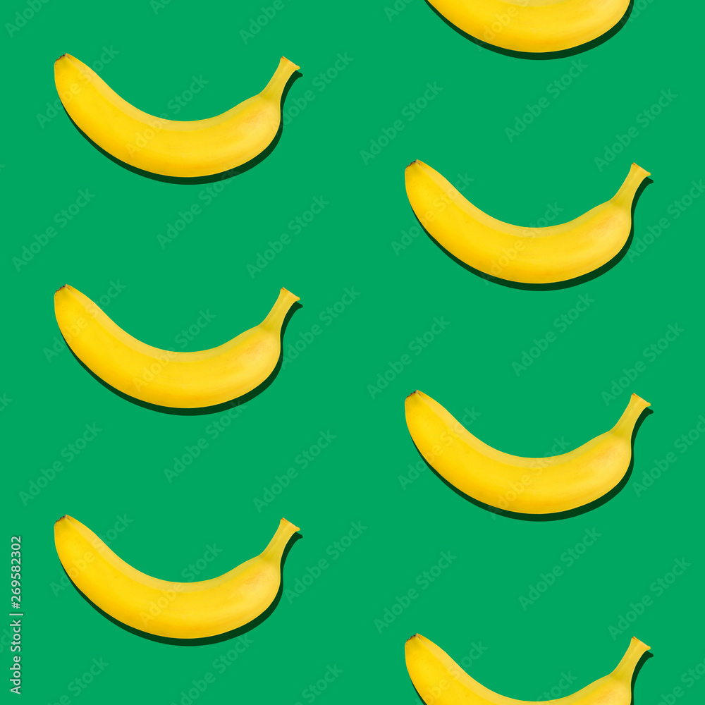 Seamless pattern of bananas on green background