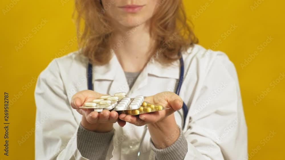 Young woman doctor. Yellow background. The concept of medicine. Young woman doctor. Yellow background. The concept of medicine.