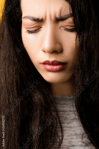 Closeup portrait of upset, regretful emotional brunette girl with disappointed, sorrowful facial expression, eyes closed.