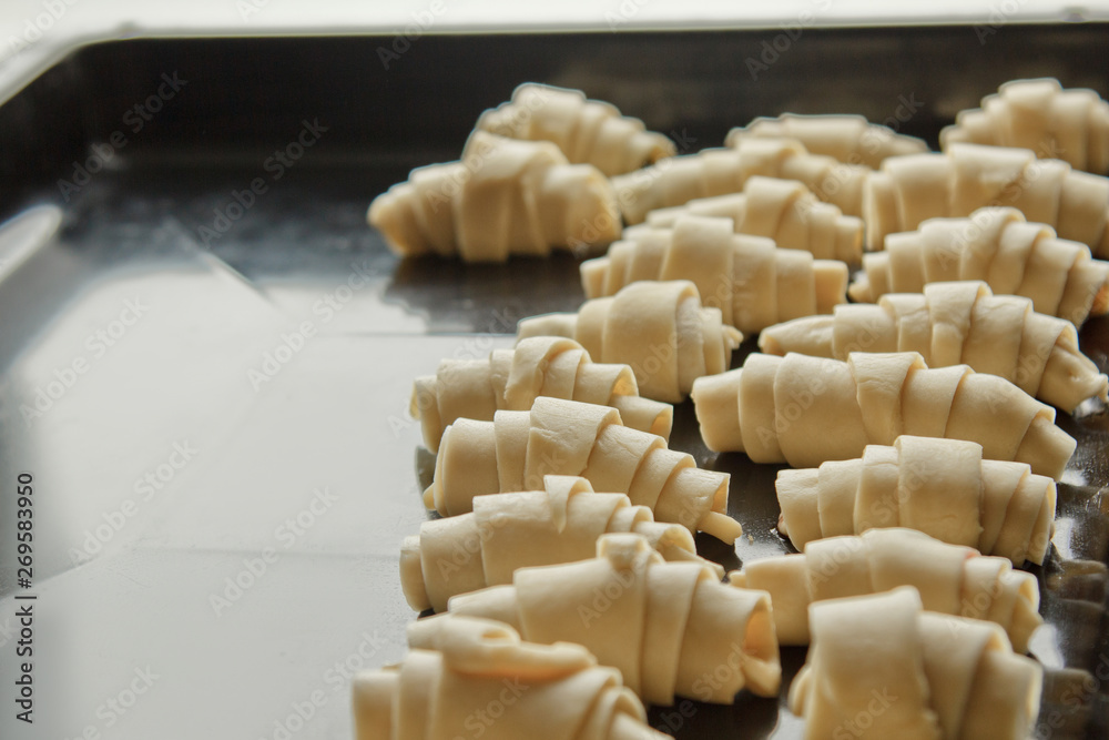 sliced raw mixed puff pastry in the shape of a bagel with berries lies on the baking tray. cooking baking dish sliced raw mixed puff pastry in the shape of a bagel with berries lies on the baking tray. cooking baking dish