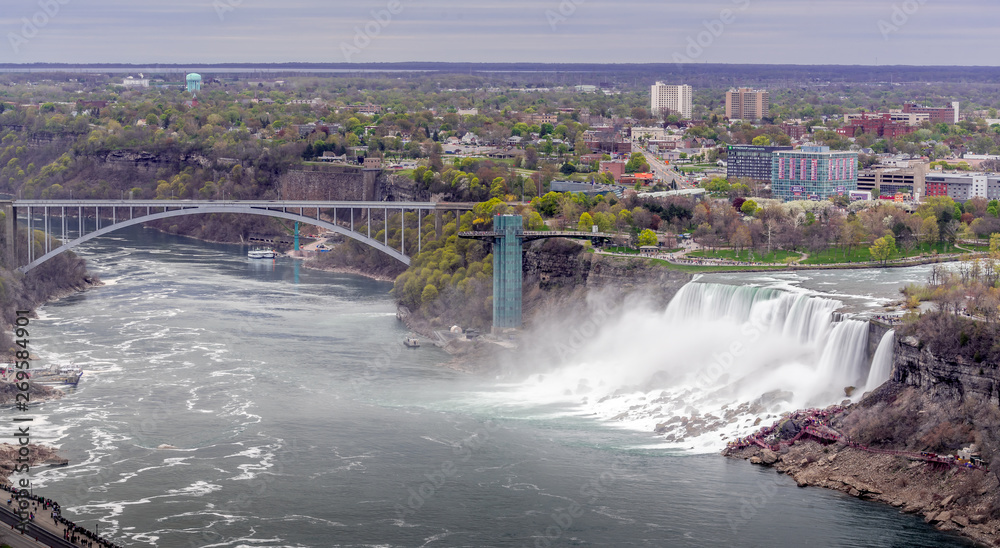 Niagara Falls, Canada - May 18, 2019. Panorama view of Niagara Falls from canada side with the bridge Niagara Falls, Canada - May 18, 2019. Panorama view of Niagara Falls from canada side with the bridge