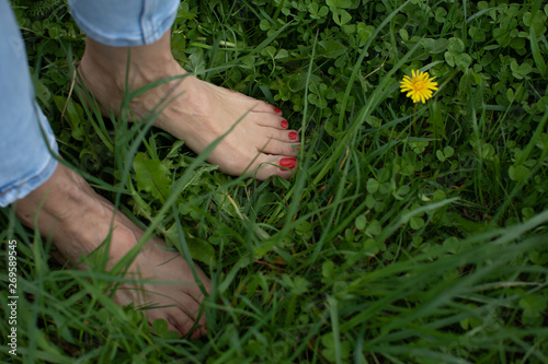 feet and hands of a woman with red manicure and pedicure