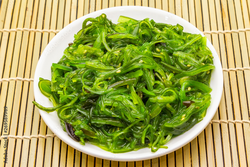 Traditional Japanese Hiyashi Wakame Chuka seaweed salad with sesame seeds.